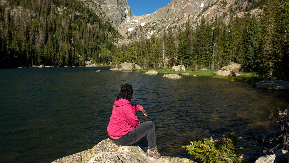 Visitor sitting and viewing Dream Lake