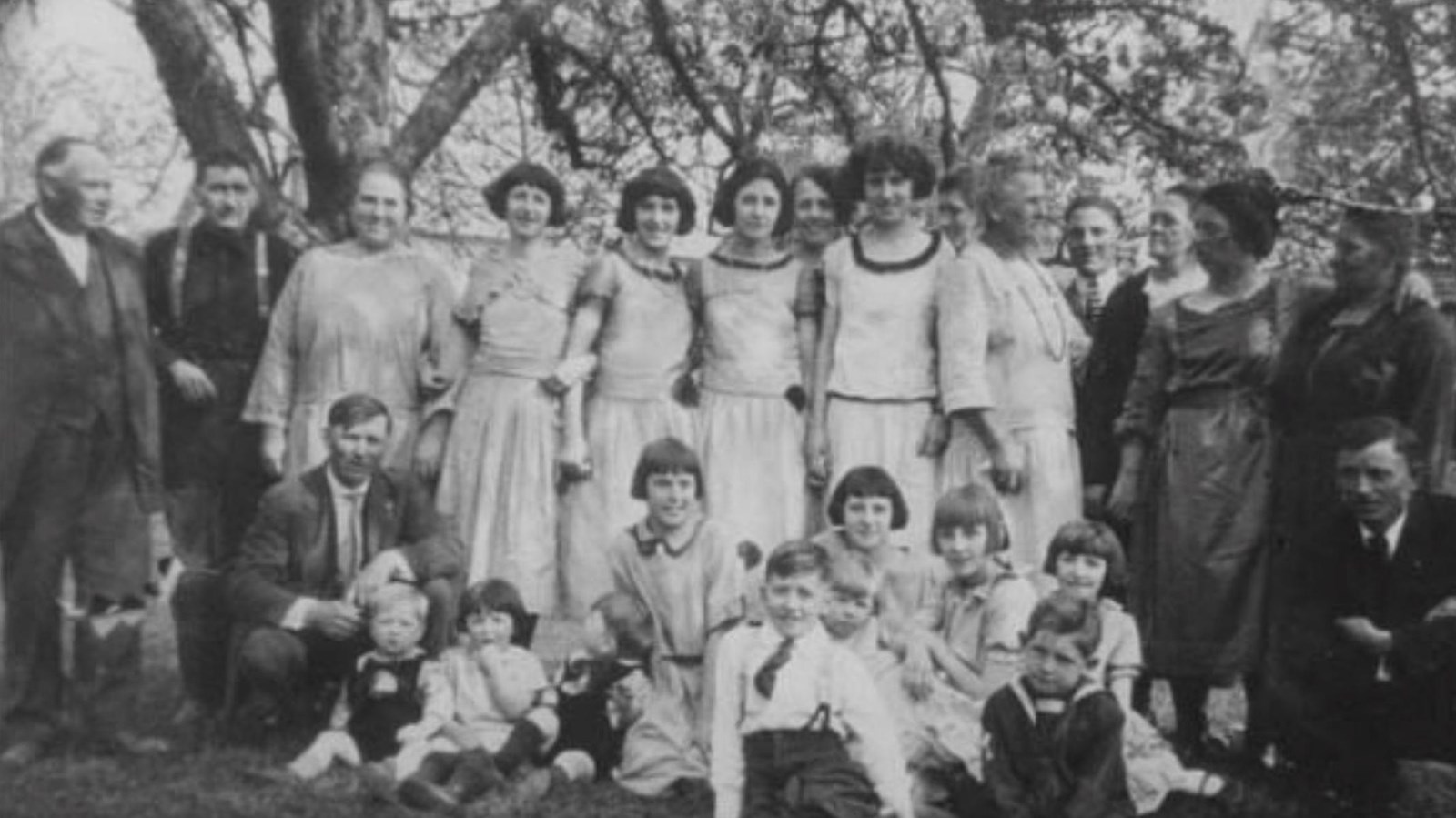 Black and white photograph of a large family assembled outdoors