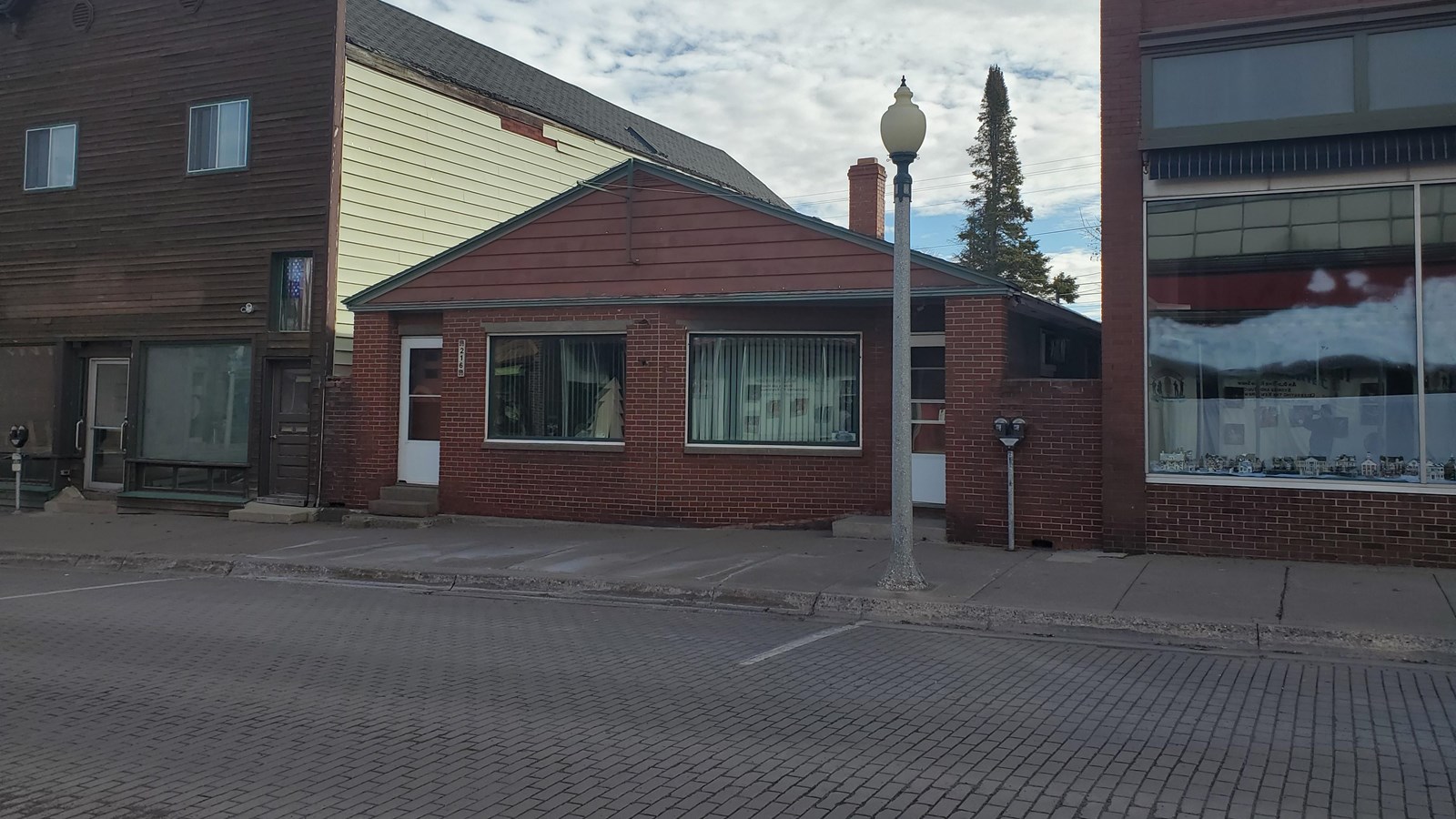 Single story brick building with shallow-pitched gabled roof