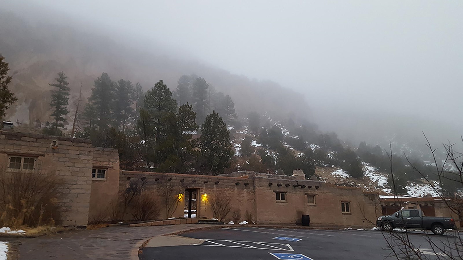 stone buildings are lit in dusky light and fog
