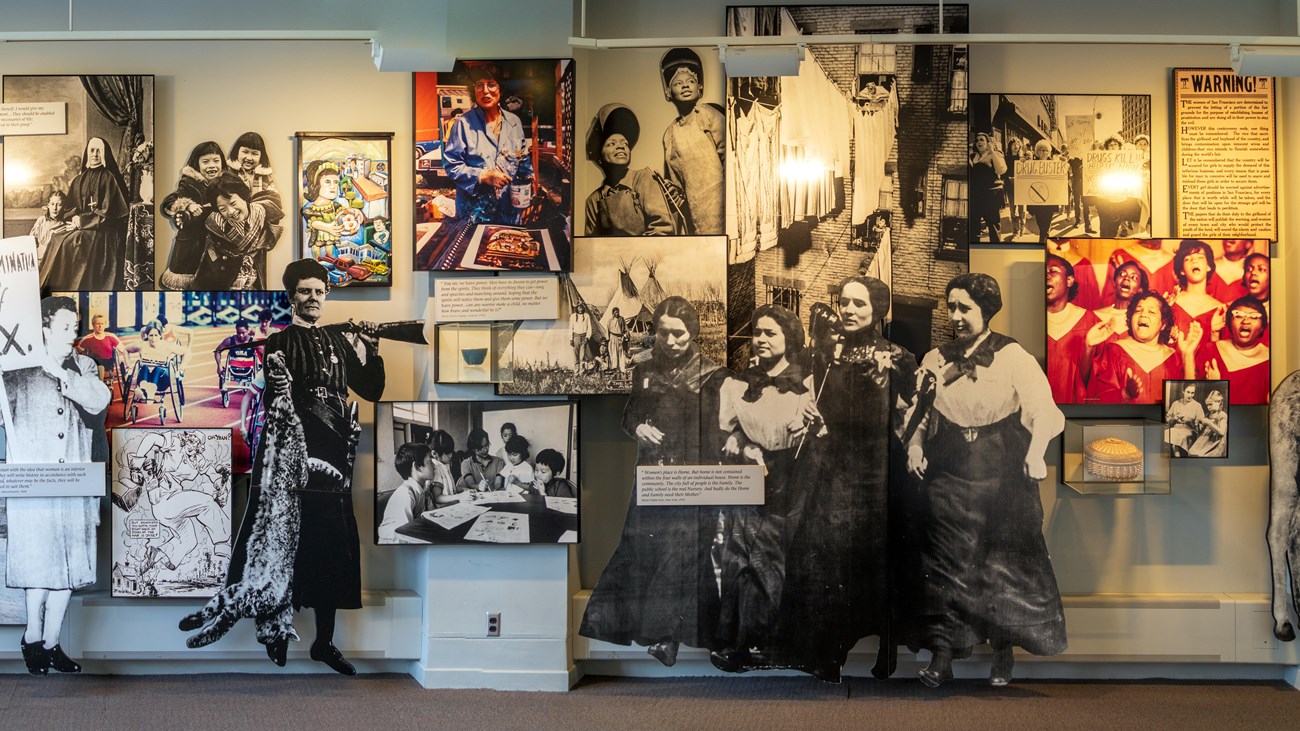 A wall of various photos in an exhibit.