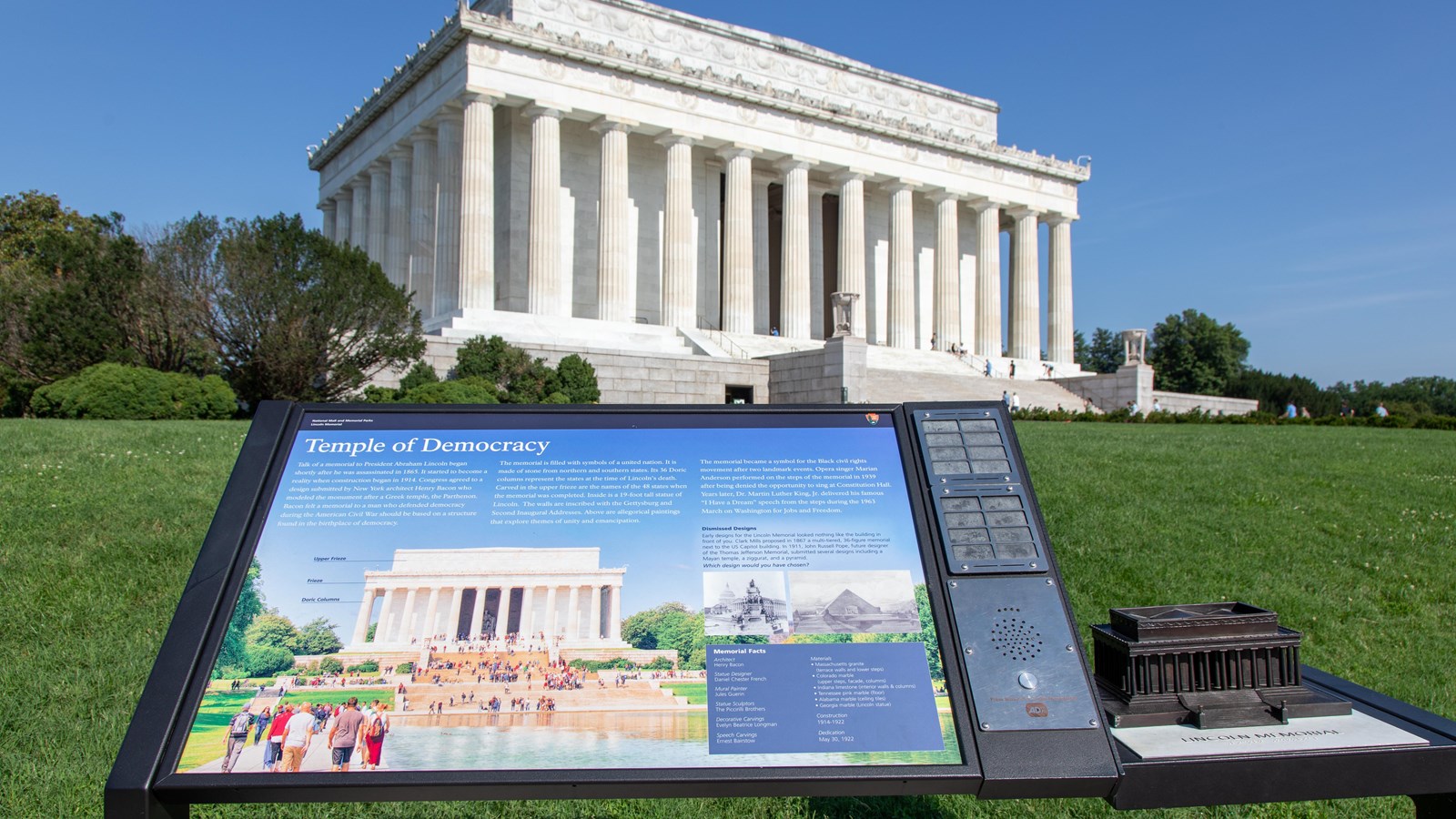 Information panel with text, images, and a model of the Lincoln Memorial in front of the memorial.