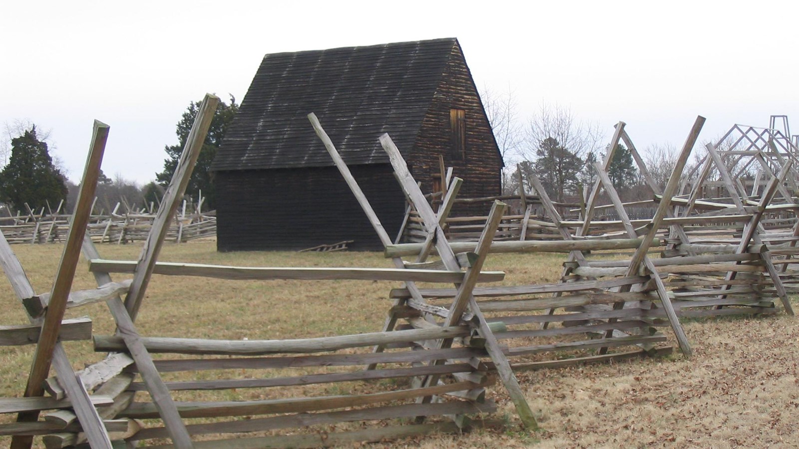 A colonial era building and fence. 