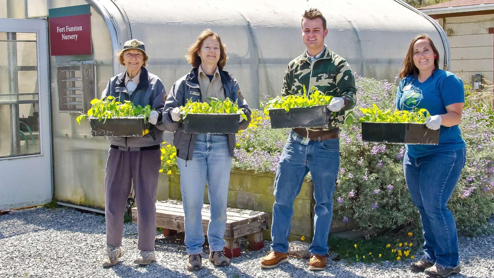 4 volunteers holding plants at the Fort Funston Nursery