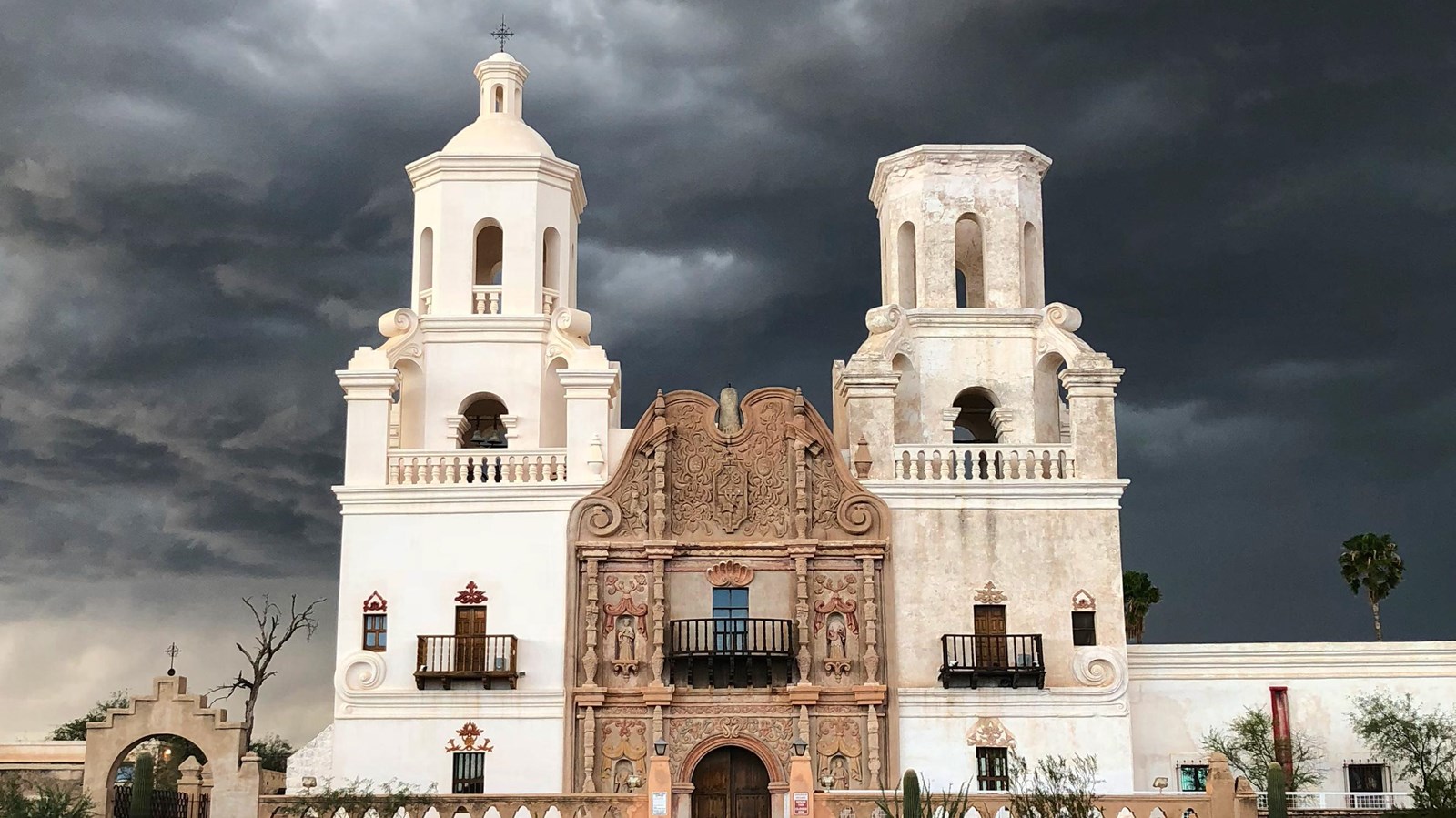 San Xavier del Bac Mission Tucson, Arizona with storm cloud behind