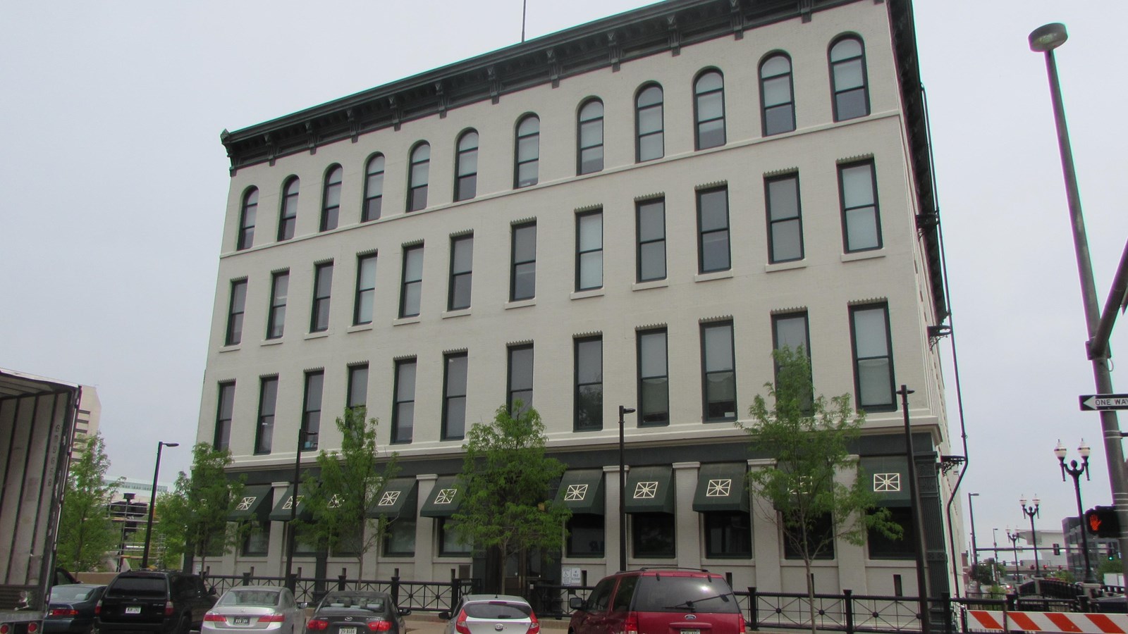Four story brick Italianate style company building. Rows of twelve windows on each upper floor.
