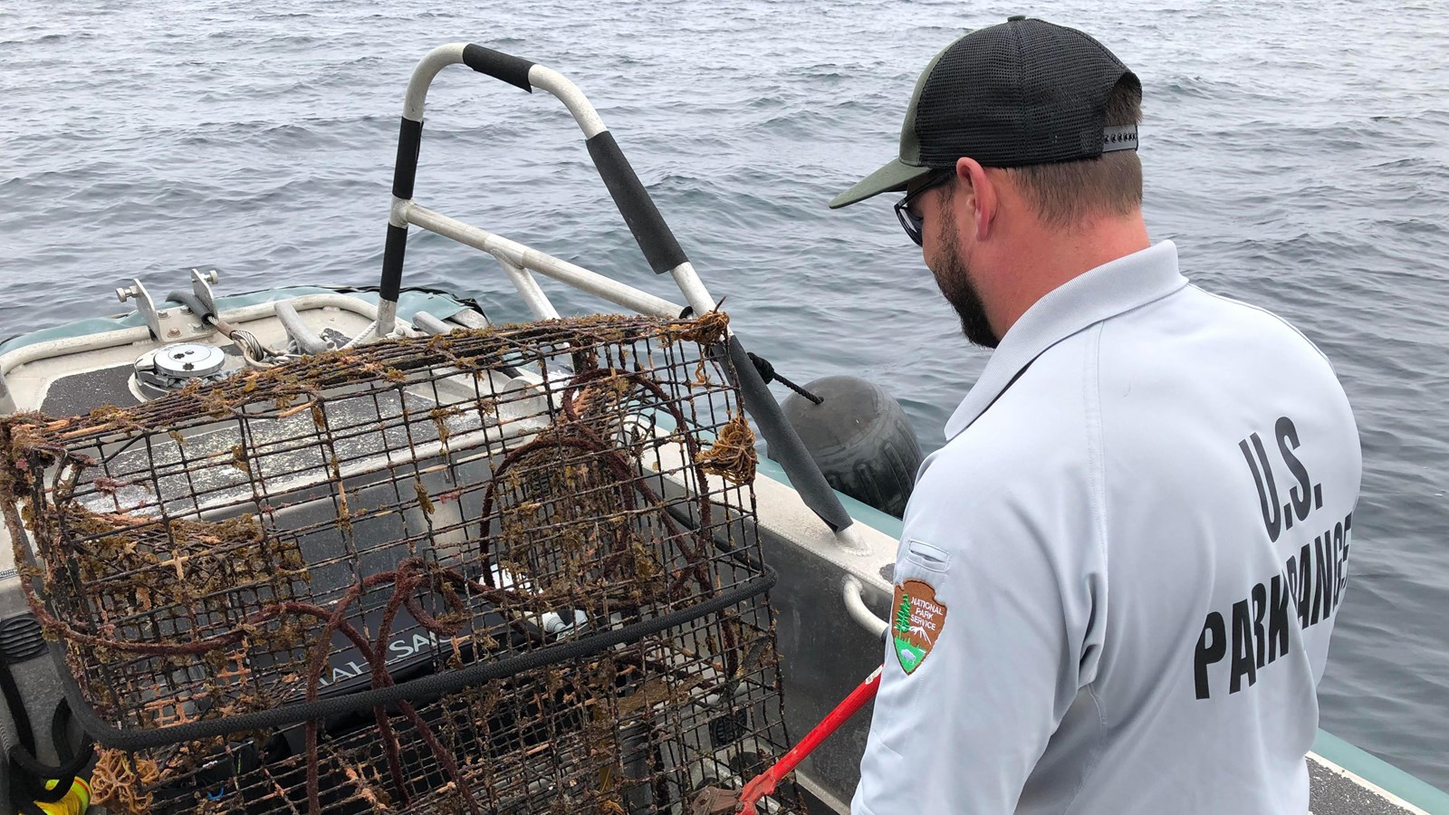 ranger on boat with lobster traps