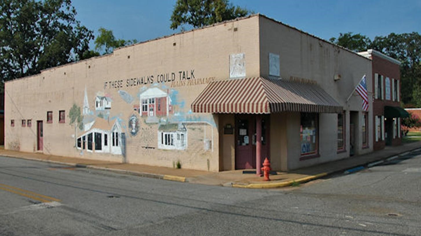 Plains Pharmacy with a mural of Plains life painted on the outside of the building