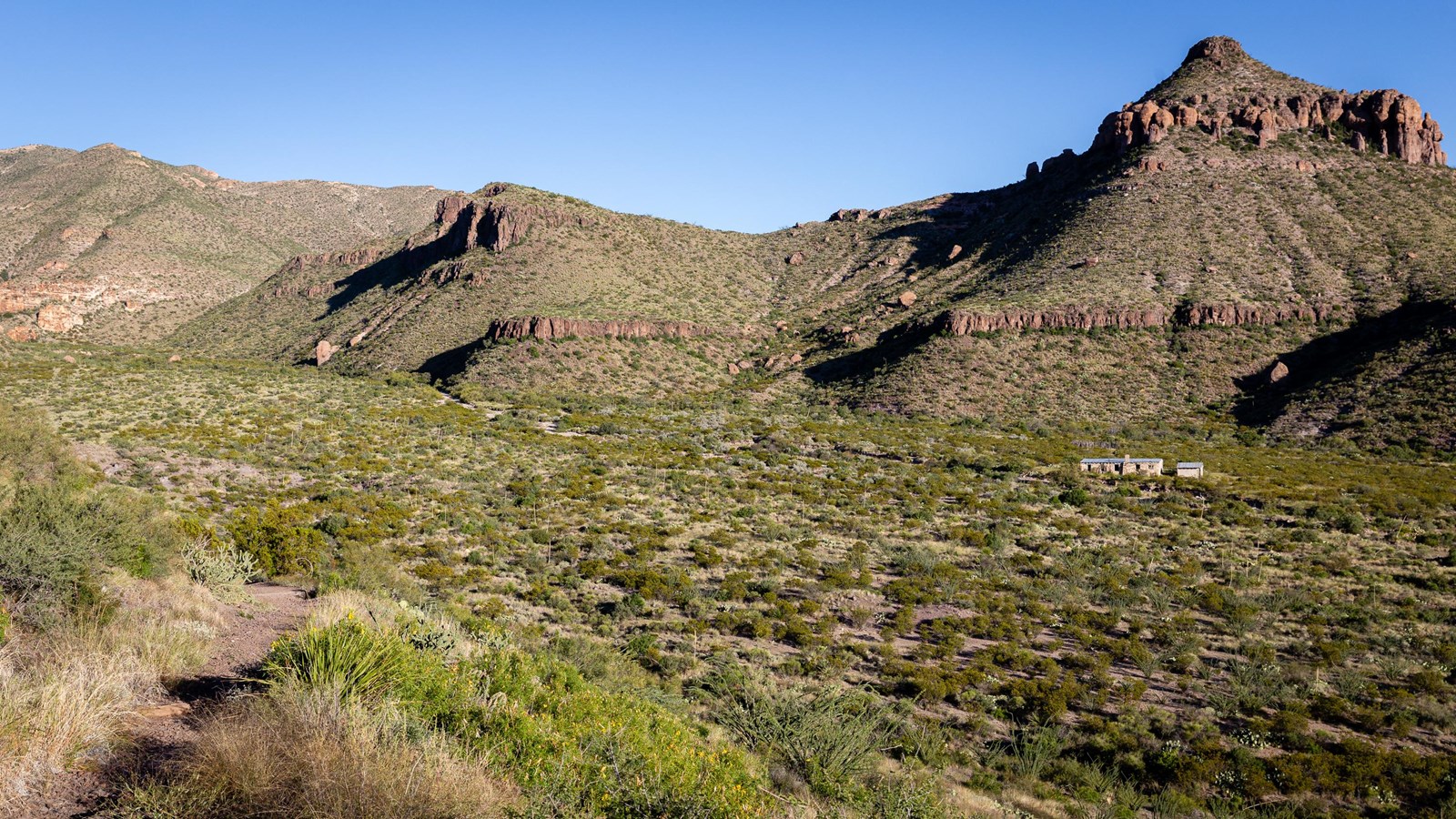 A dirt trail leads down to the Home Wilson Ranch line camp.