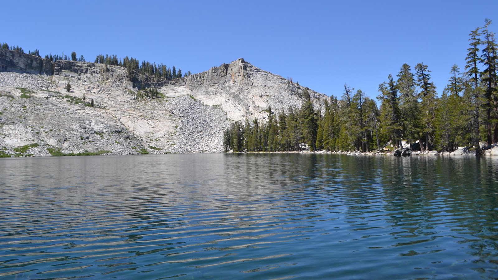 Lake with granite peaks around it.