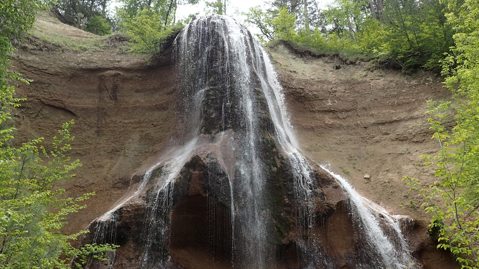 A waterfall in summer on a cloudy day