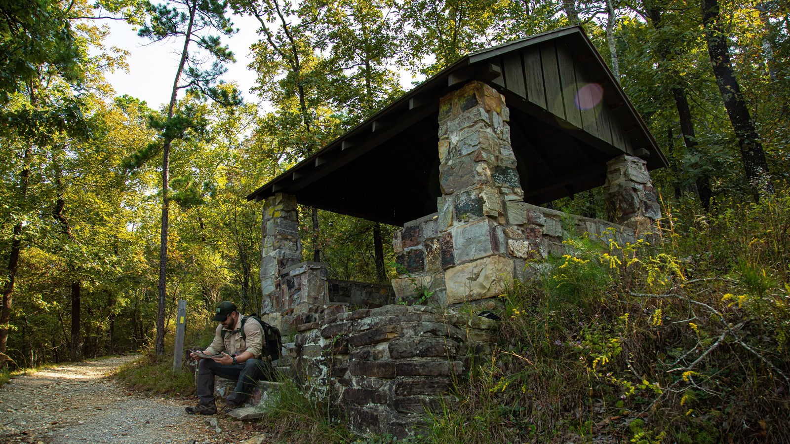 A man resting beneath a stone shelter