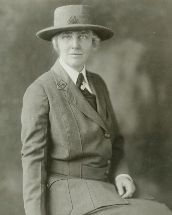 A 1925 portrait photo depicts a 51 year old woman in a girl scouts uniform.
