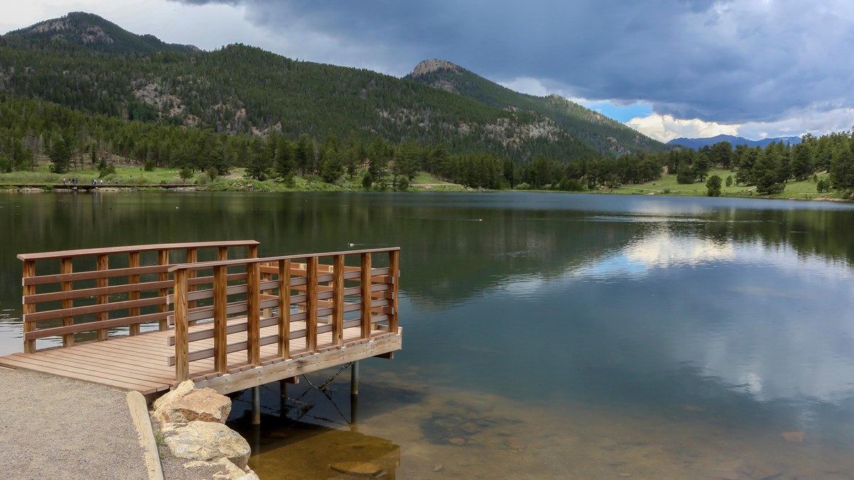 a dock jutting out toward a lake