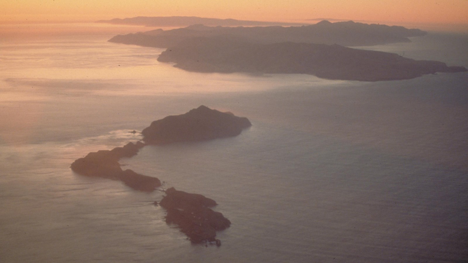 image taken from plane of 3 islands at sunset