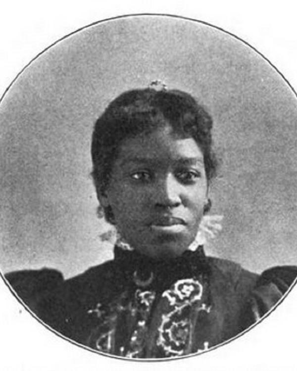 Portrait of an African American woman with a high collared dress with embroidery.