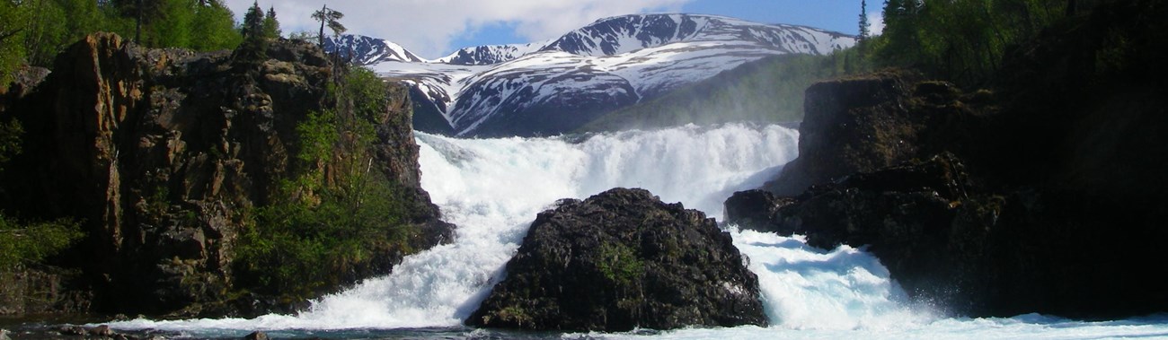 A raging water fall on a sunny day