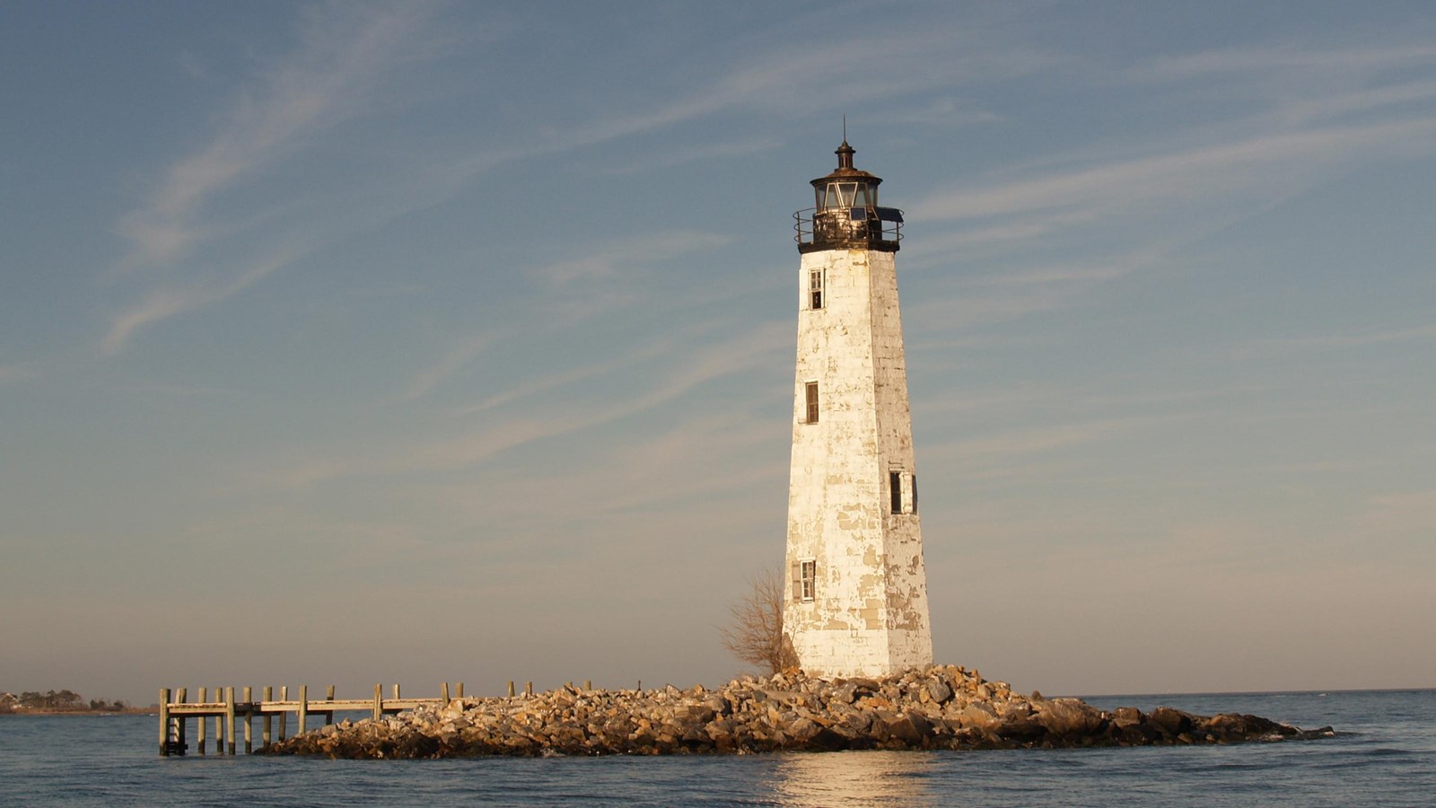 A lighthouse on a small island.