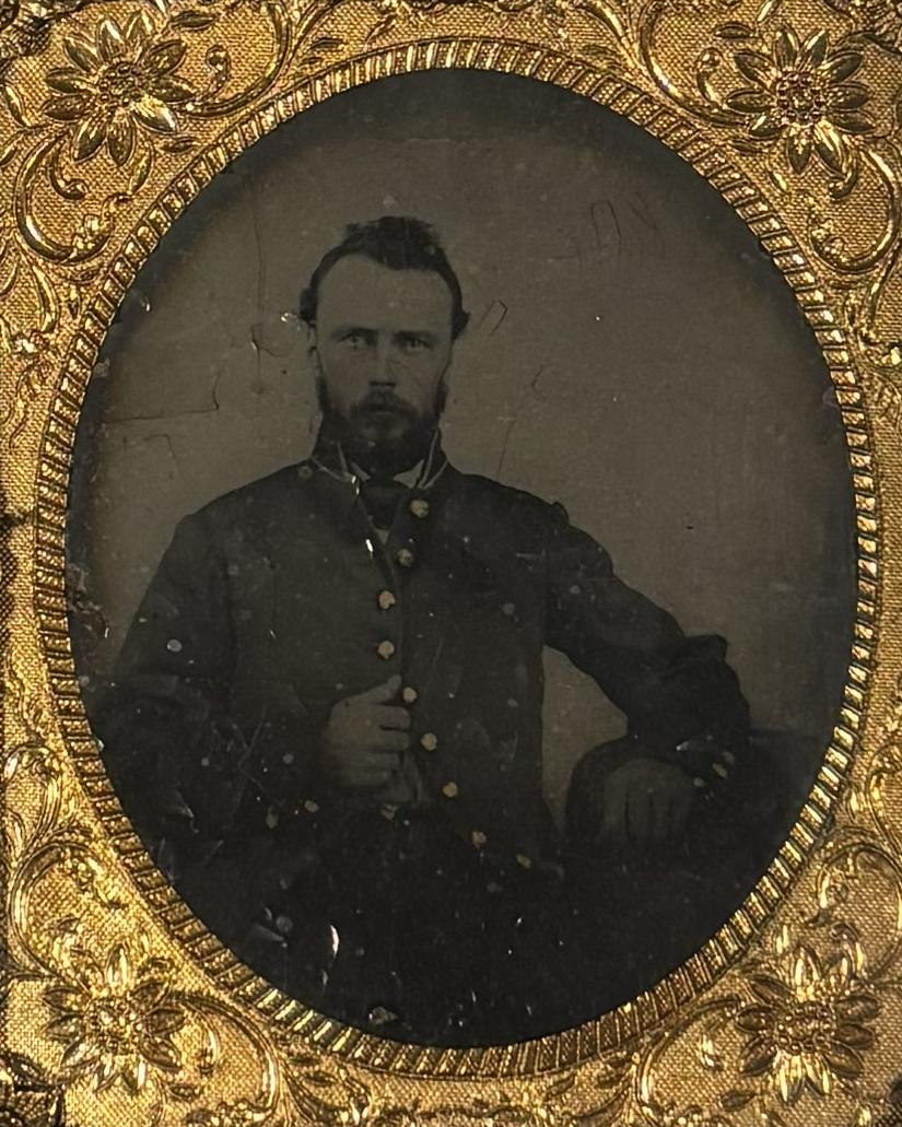 Young man sitting in a chair and posing for his photo. 