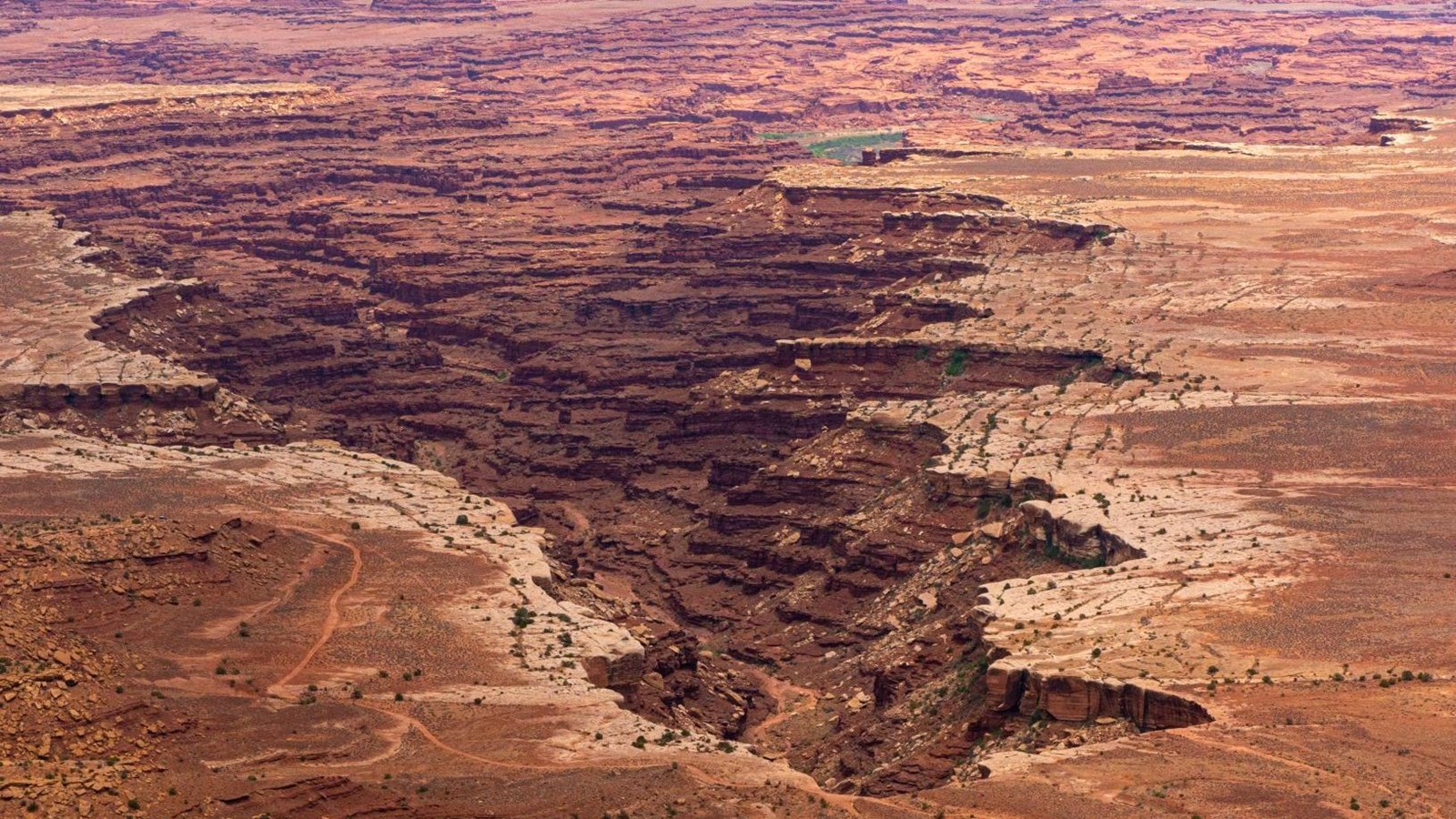 A sweeping view of multi colored canyons on a cloudy day