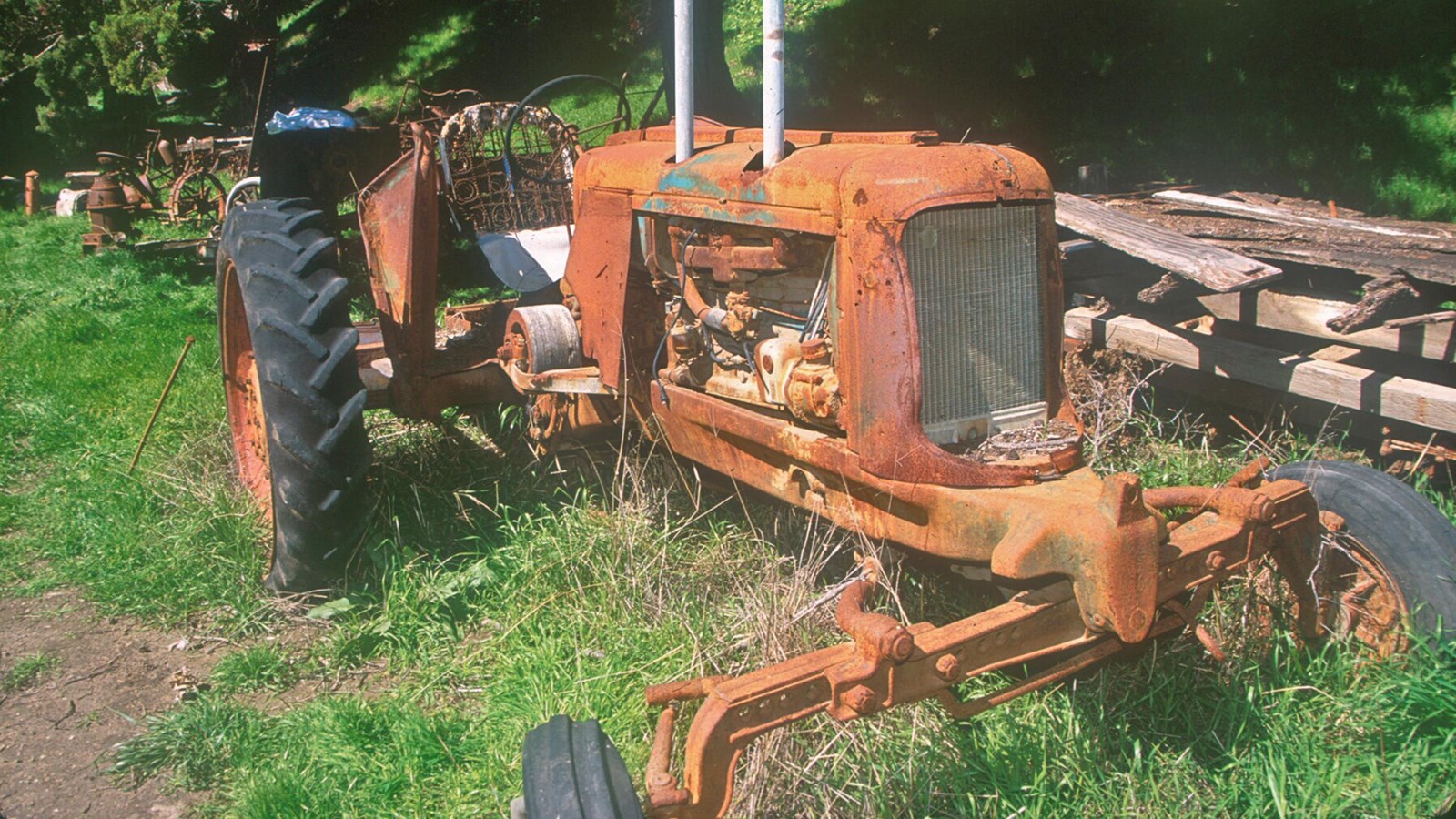 old rusted tractor sitting in grass