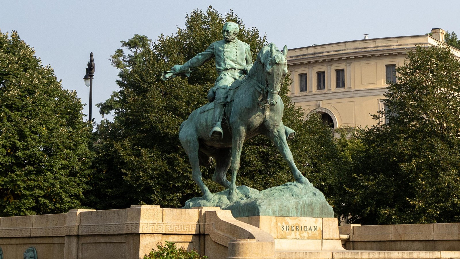 Large bronze statue of a man in military uniform on a horse