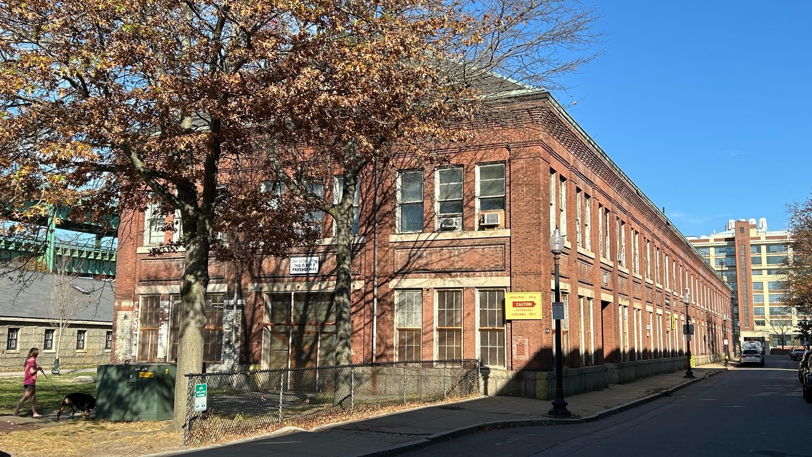 A long rectangular brick building with two-stories. The facade is the short end of the rectangle.