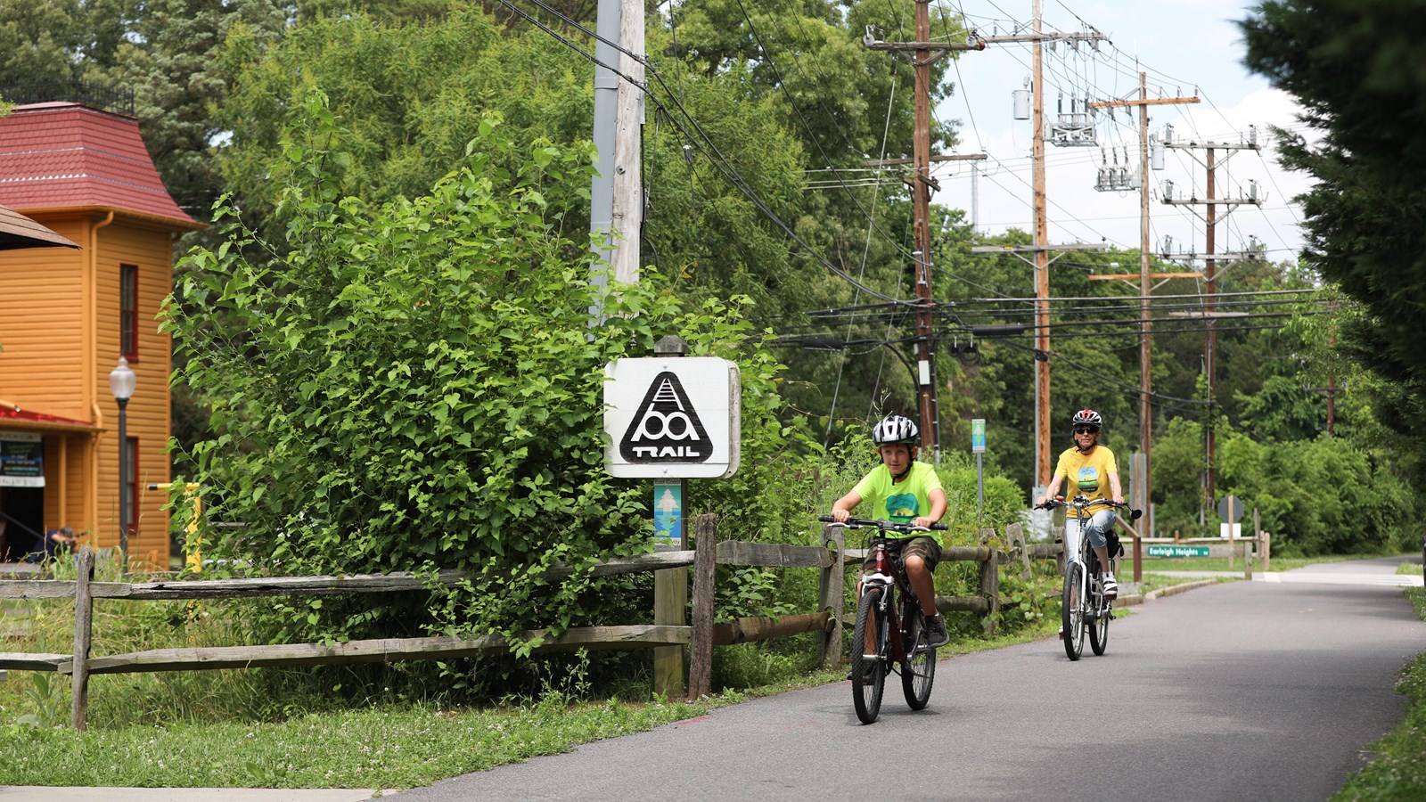 Two cyclists riding on one of the paved trails within the Chesapeake Crossroads Heritage Area.