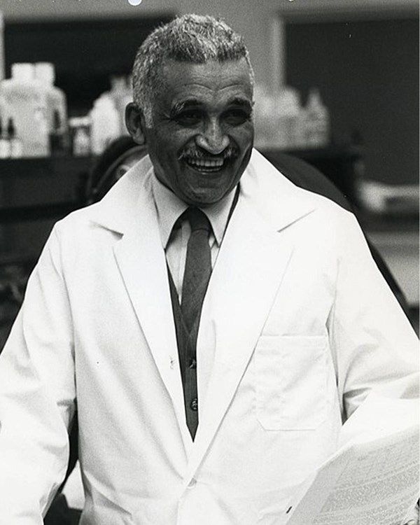 Samuel P. Massie in a lab coat smiles at the camera.