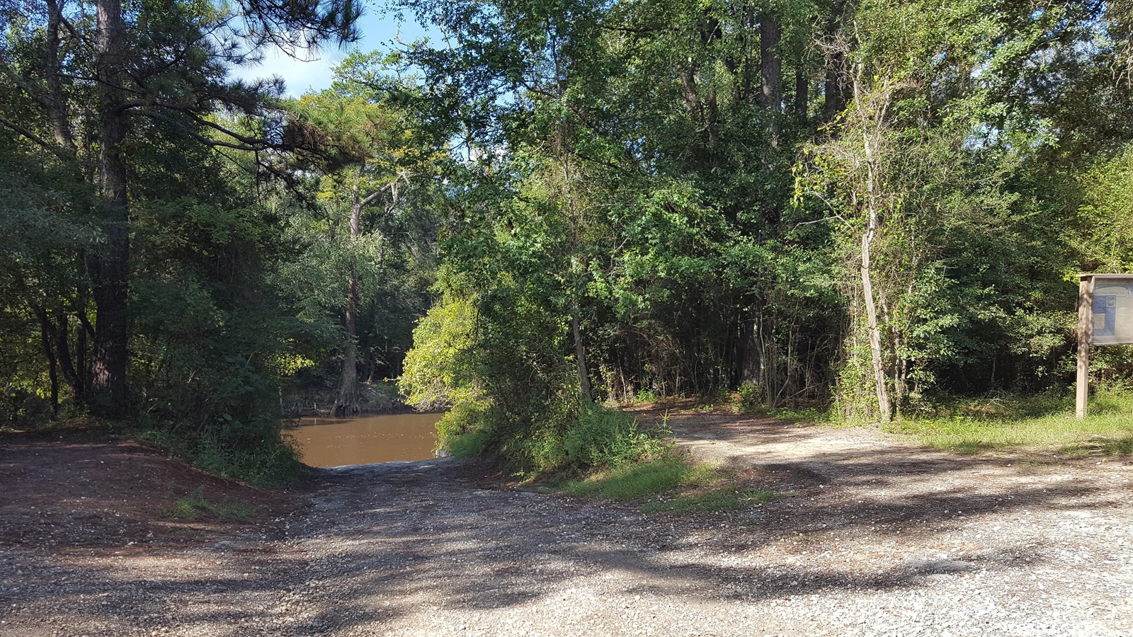 dirt boat ramp leading down to a river