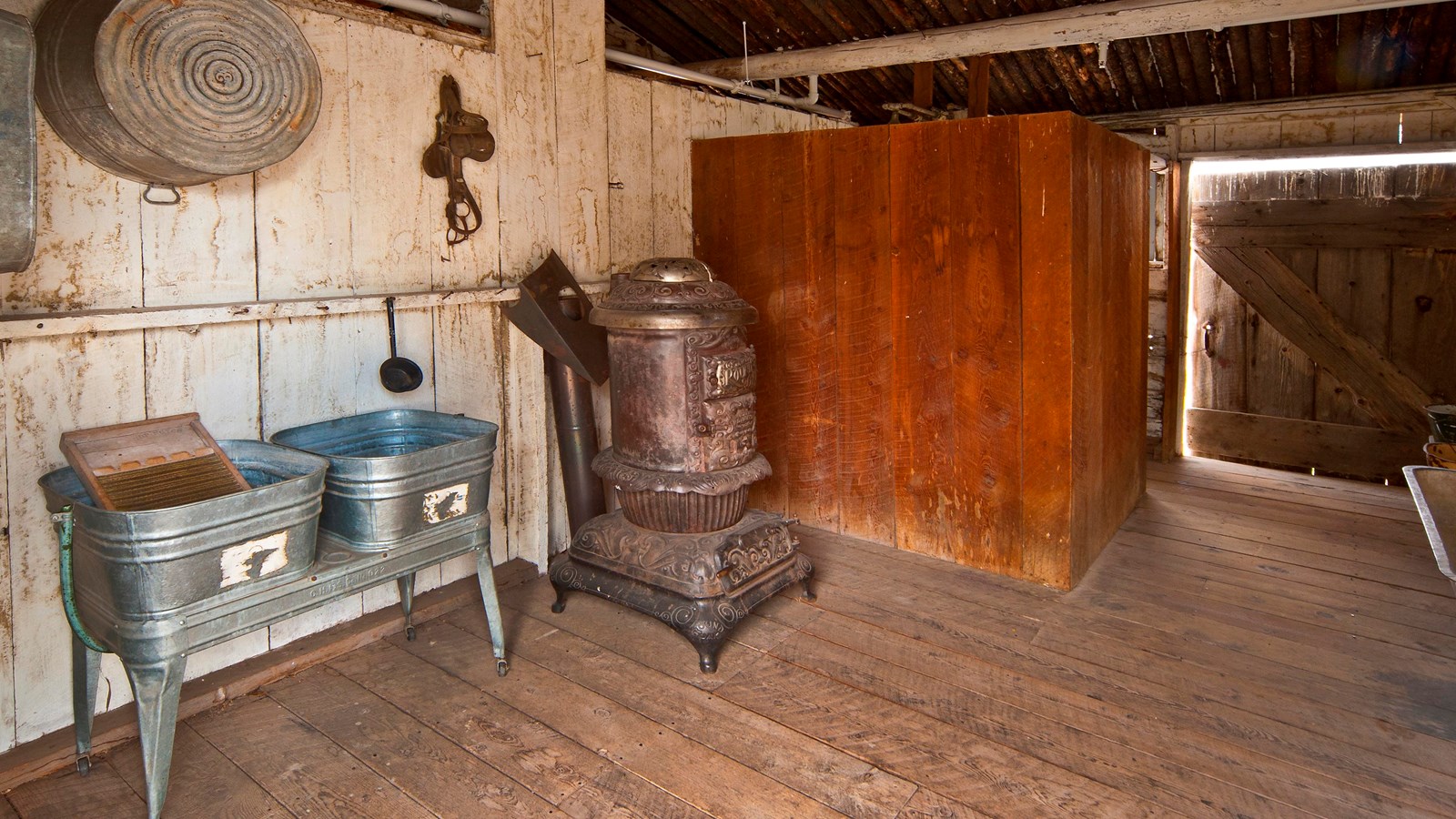 This room has a drain on the floor, several small wash tubs and a separate area for showering.