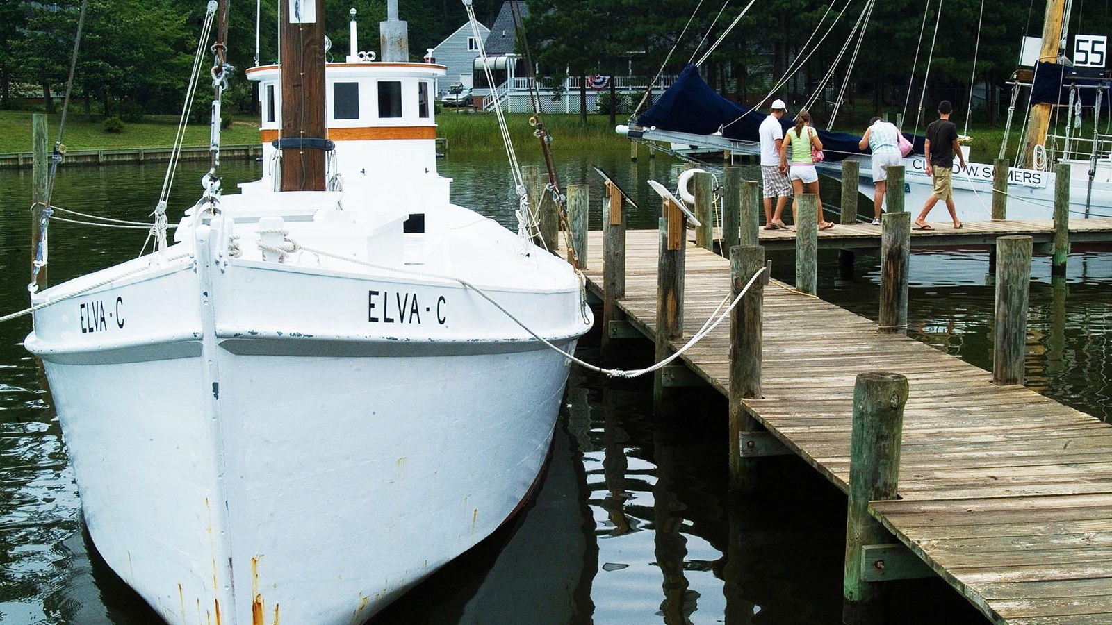 A small sailboat docked at a pier. 