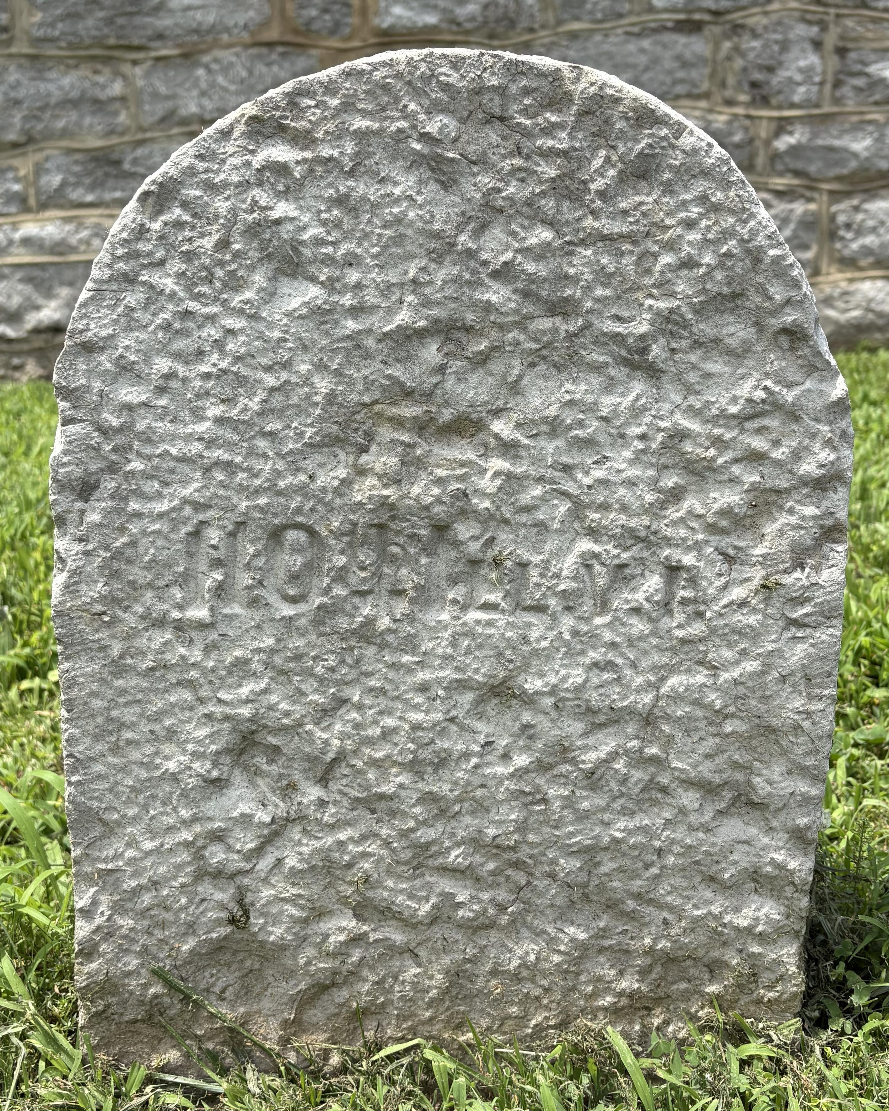 Stone headstone with "110th Ill. V. I" inscribed on its face. 