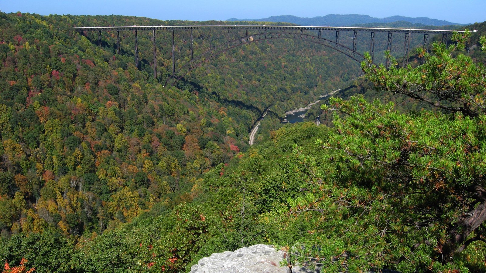 A view of the New River Gorge Bridge spanning river and deep gorge