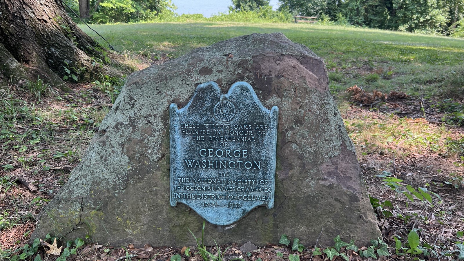 A plaque attached to a boulder.