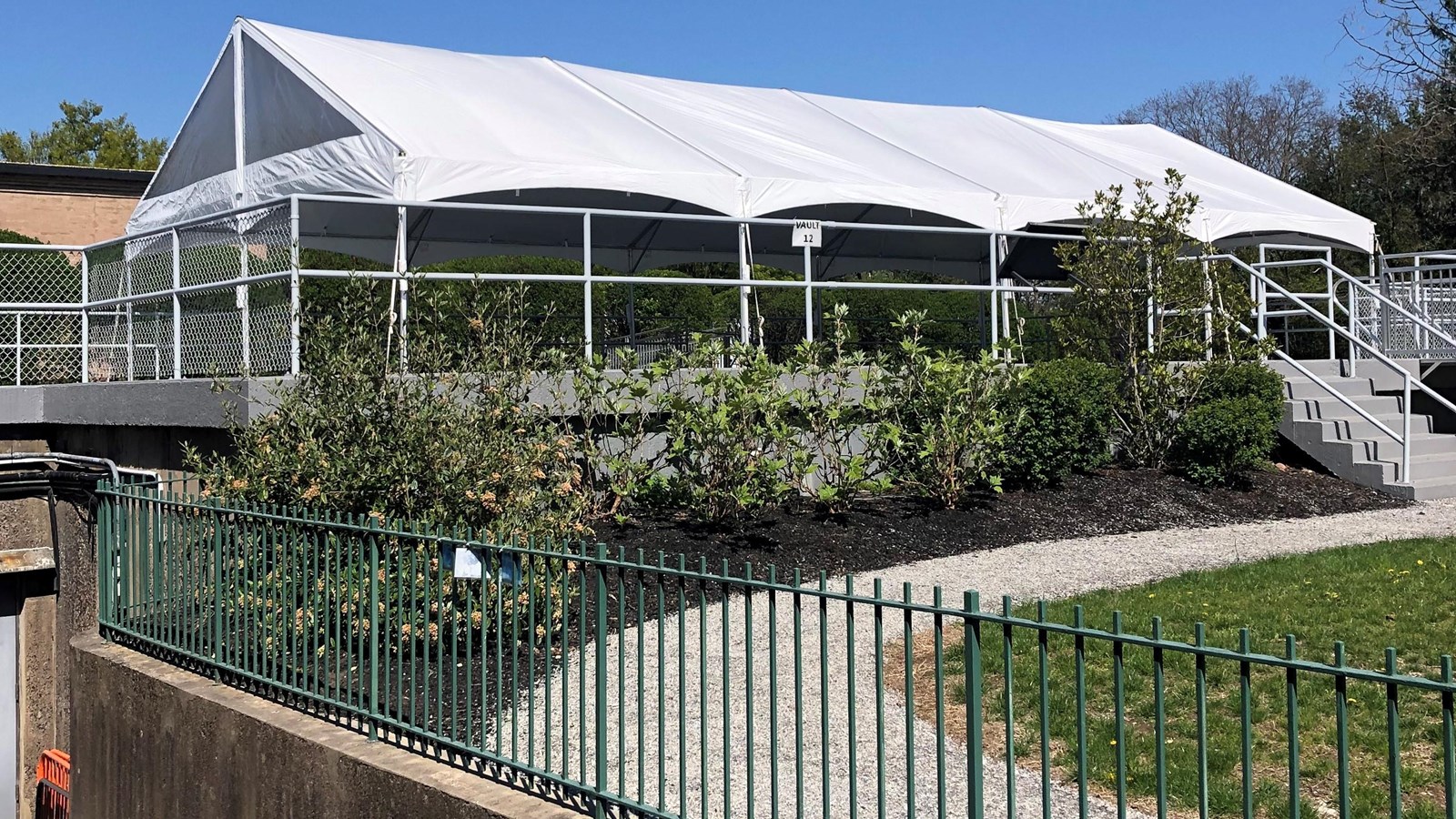 Exterior of underground vault. Roof showing with white tent structure.