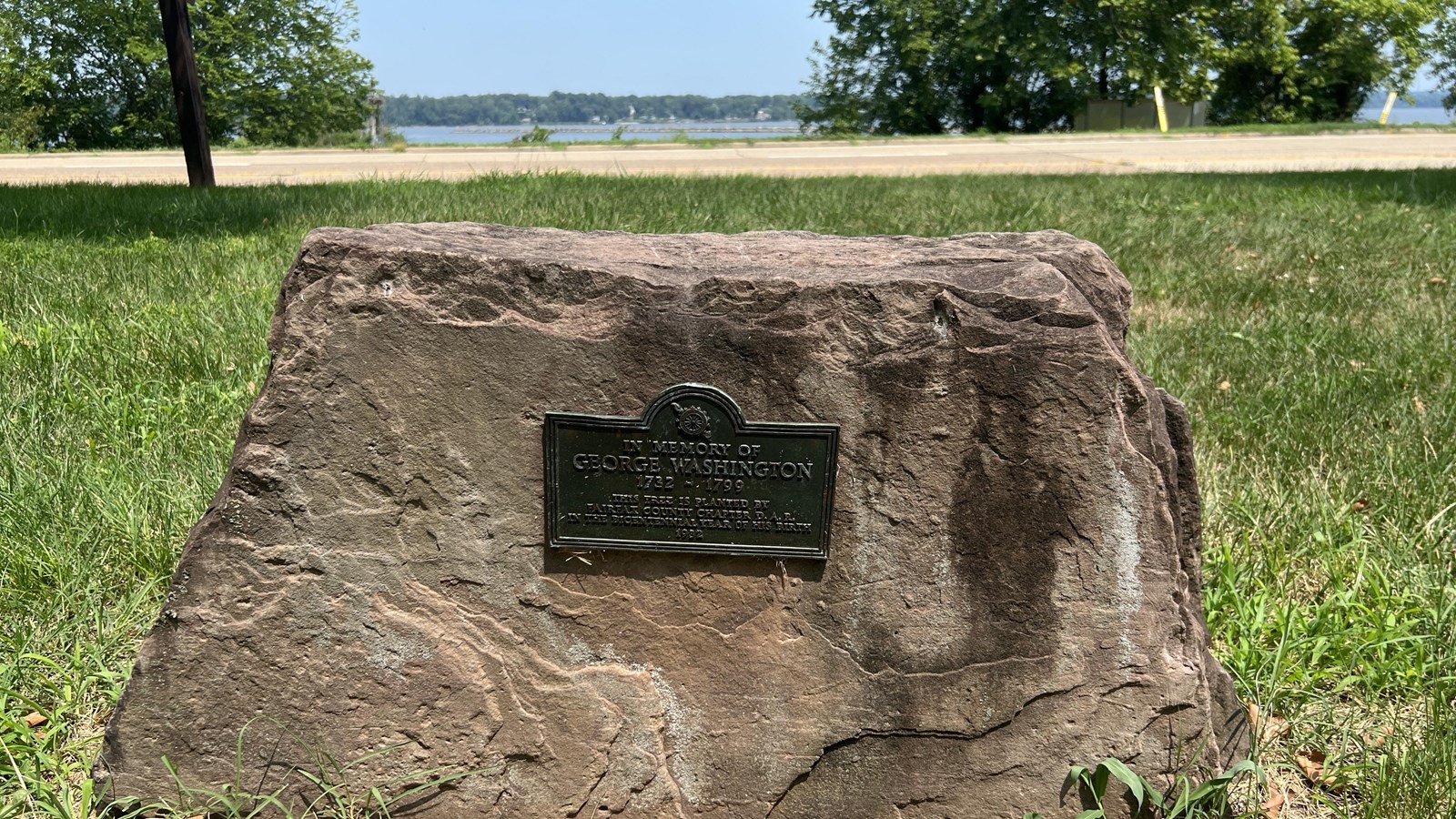 A small plaque on a small stone.