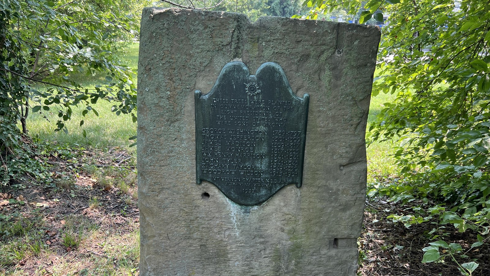 A plaque attached to a boulder.