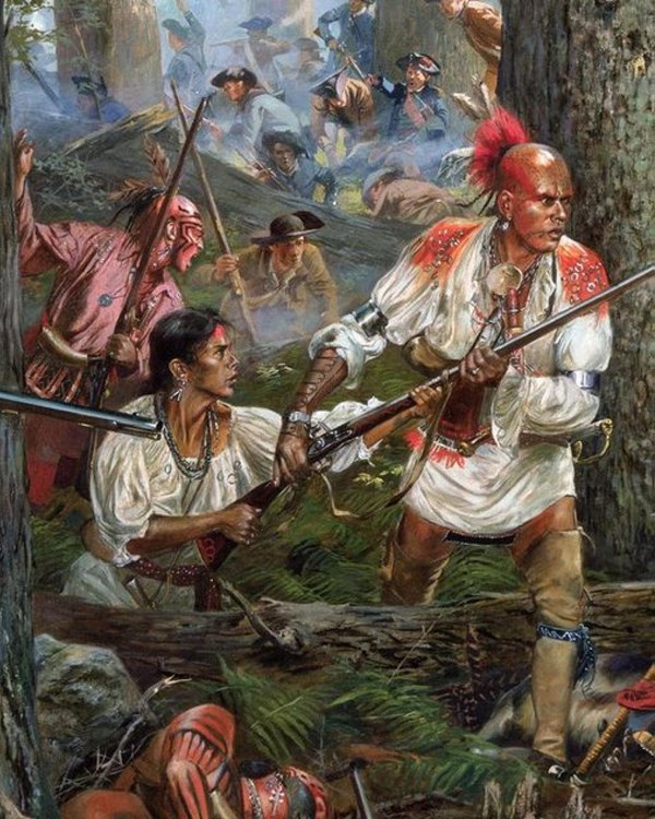 A woman crouched behind a fallen tree hands a musket to a man in front of her.