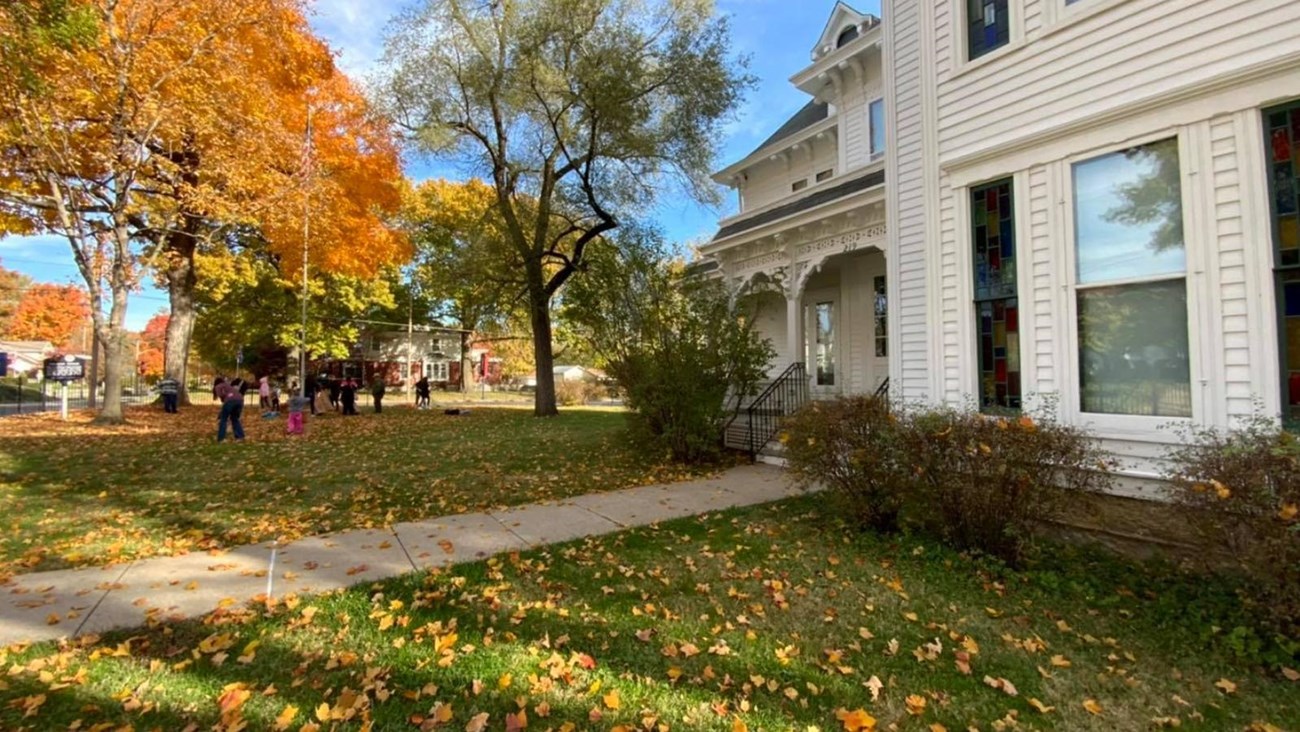 West side of Truman Home, autumn colors on trees and leaves on the ground