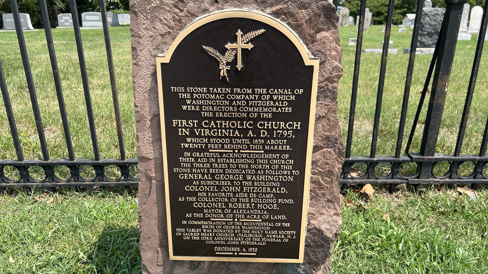 A plaque attached to a stone.