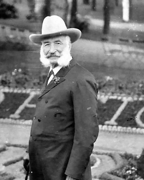 Man poses outside in a suit