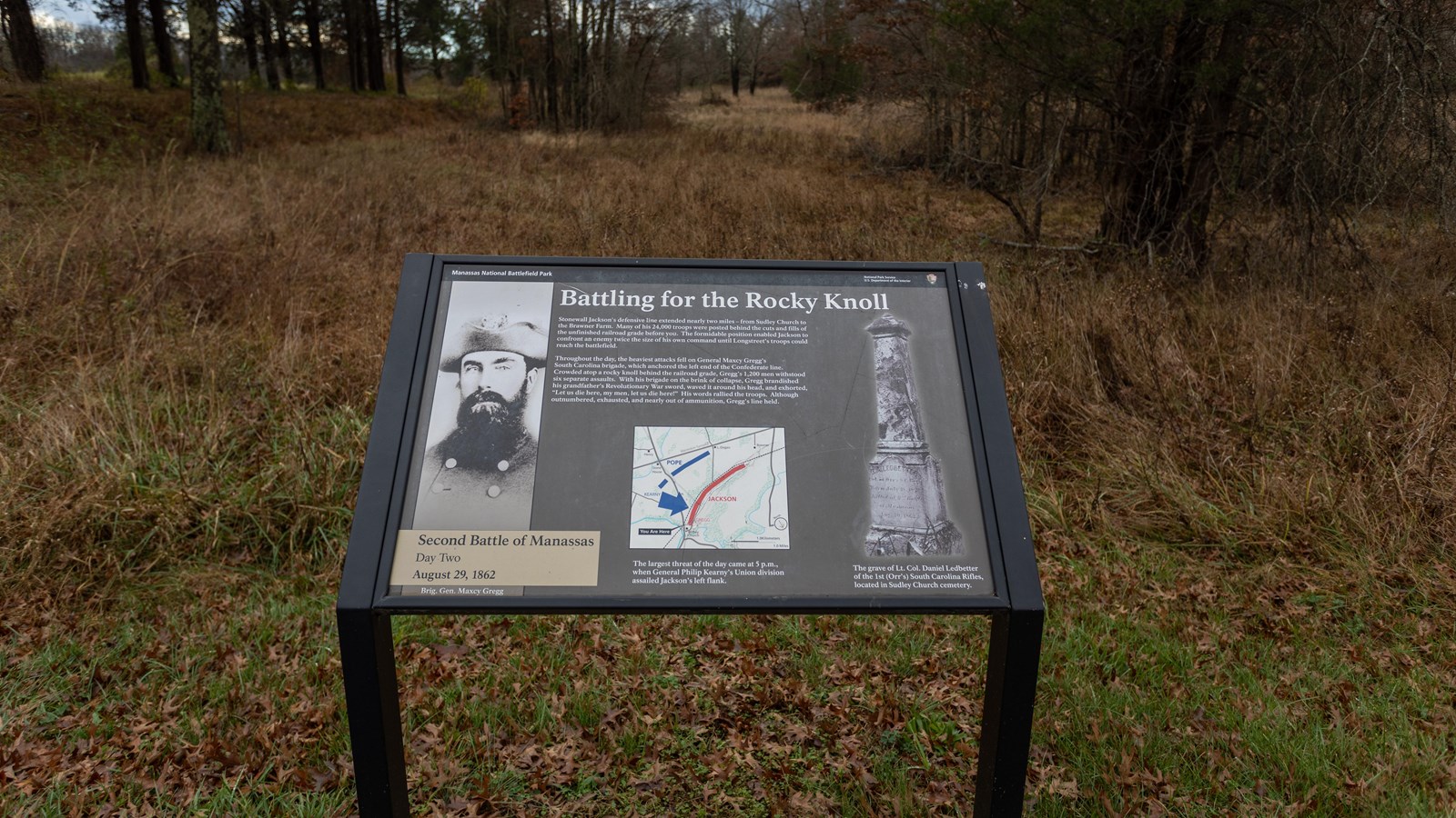 An image of a soldier with a beard is depicted to the left of picture of a gravestone.
