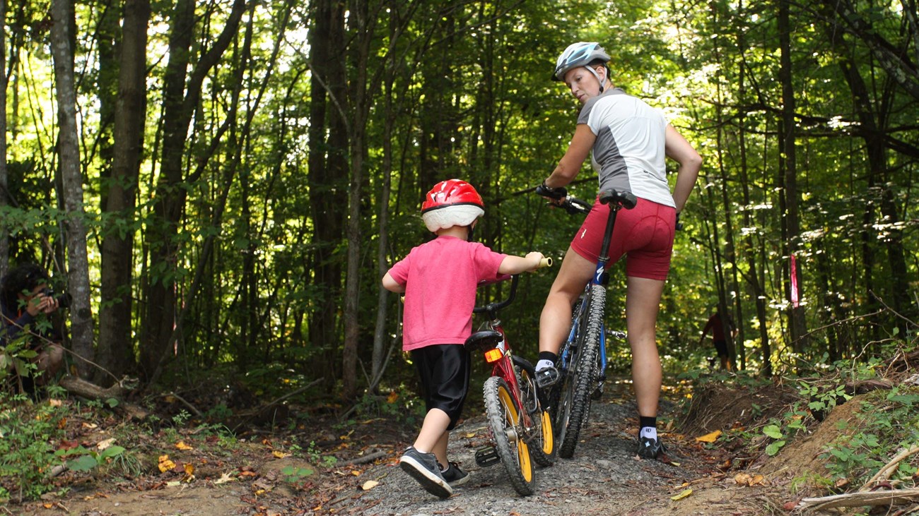 mother and child riding bikes on a trail