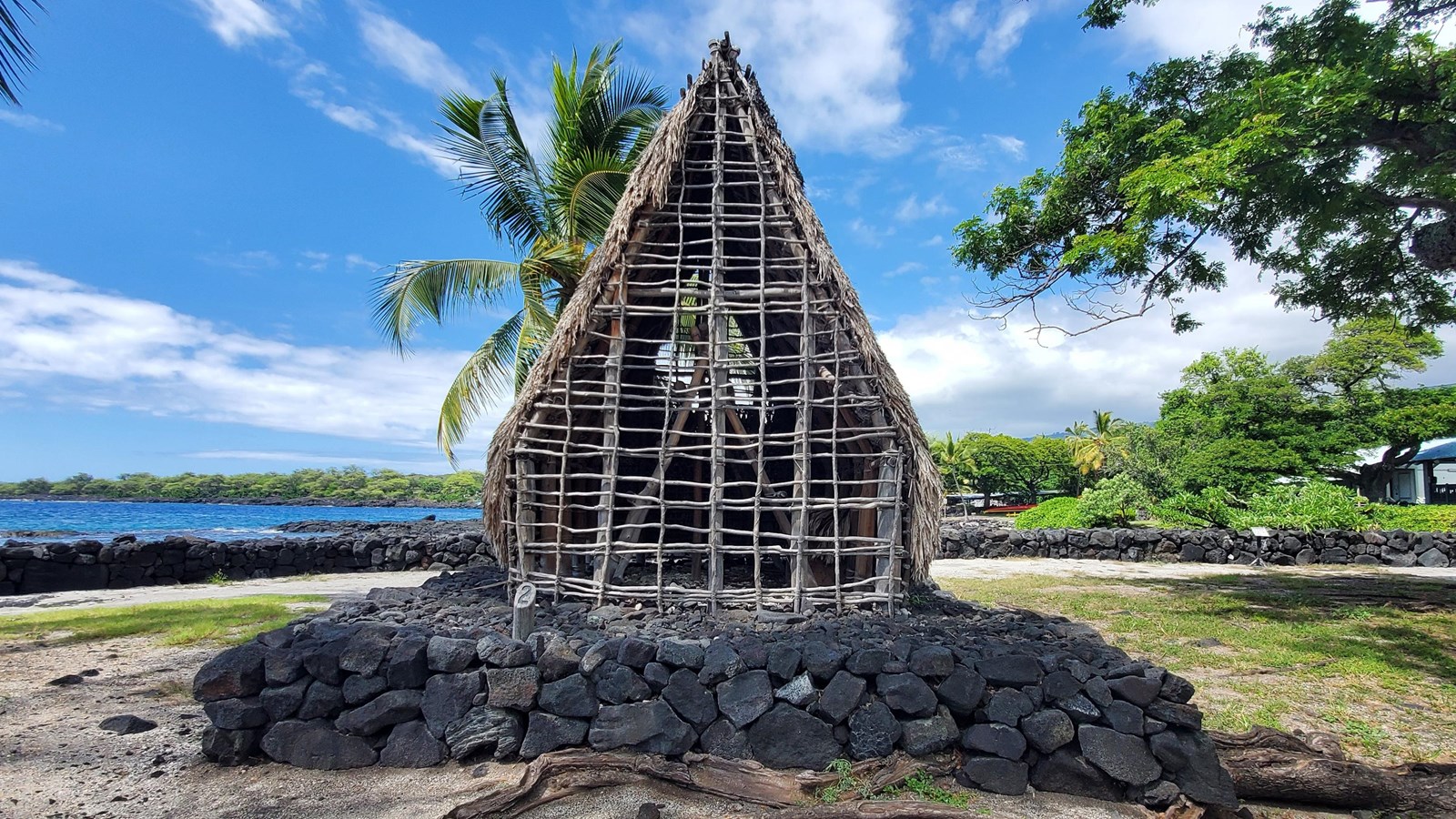 A small reconstruction of Hale o Keawe stands atop a rock platform