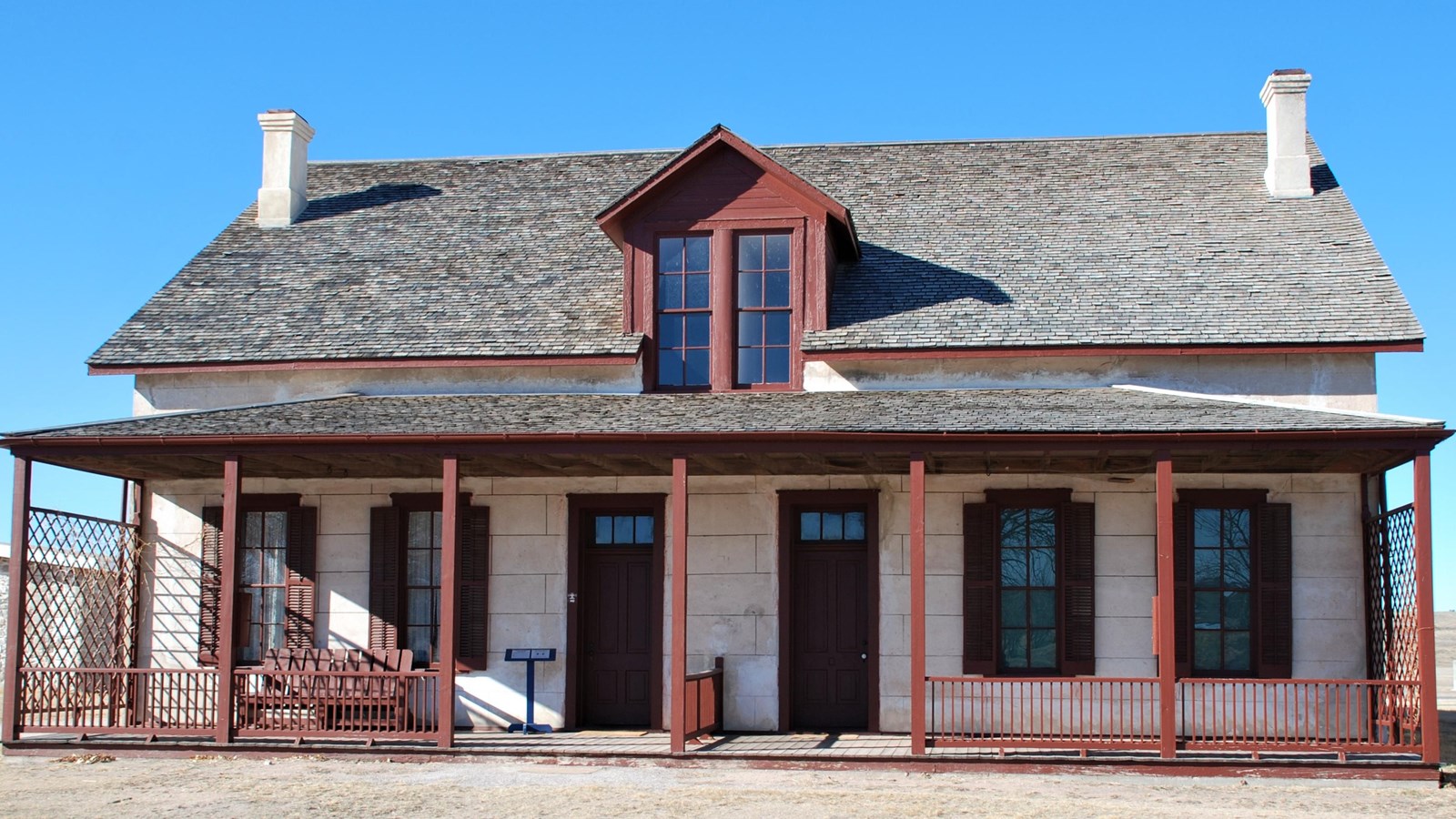 A two-story lime-grout duplex with a front porch.