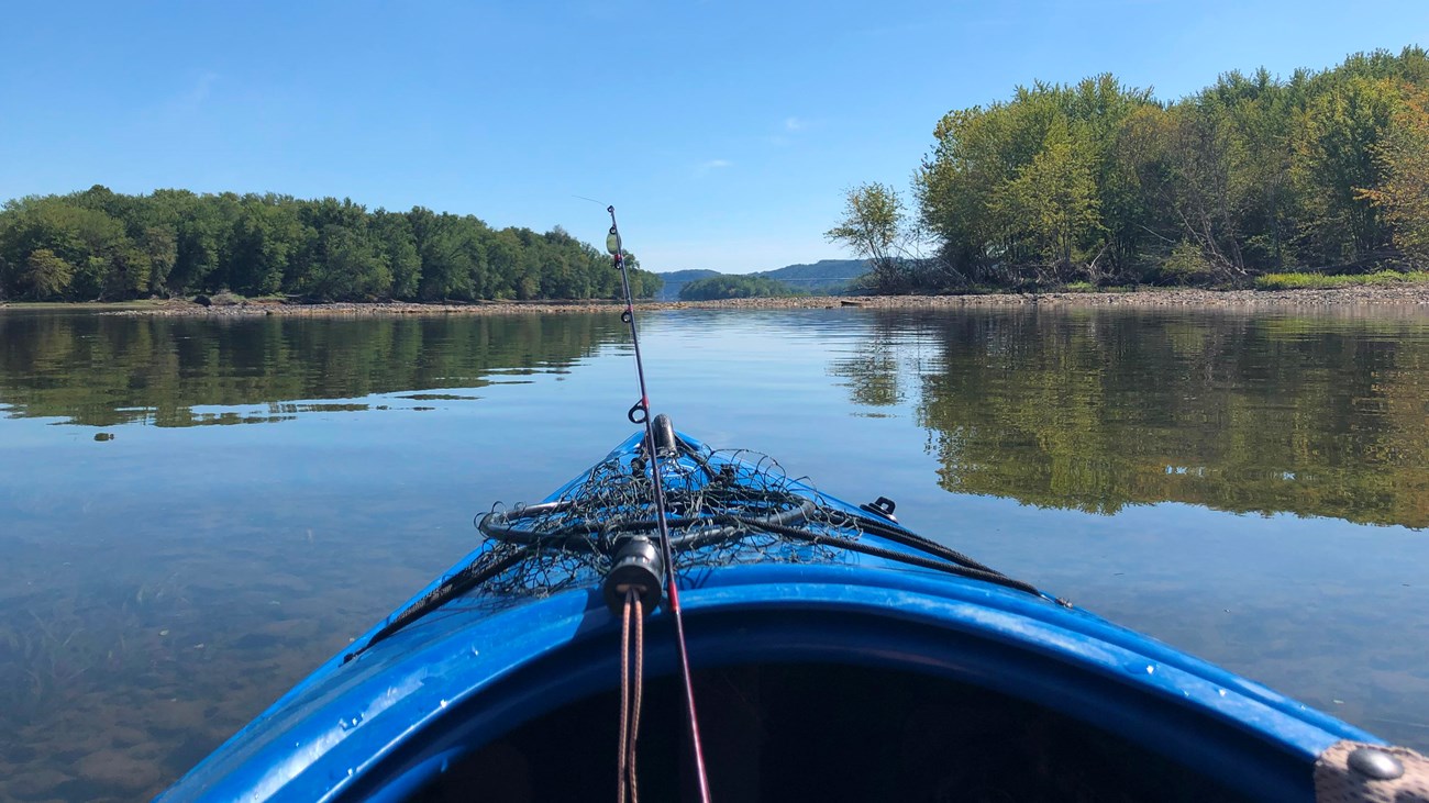 Blue kayak on calm, reflective waters