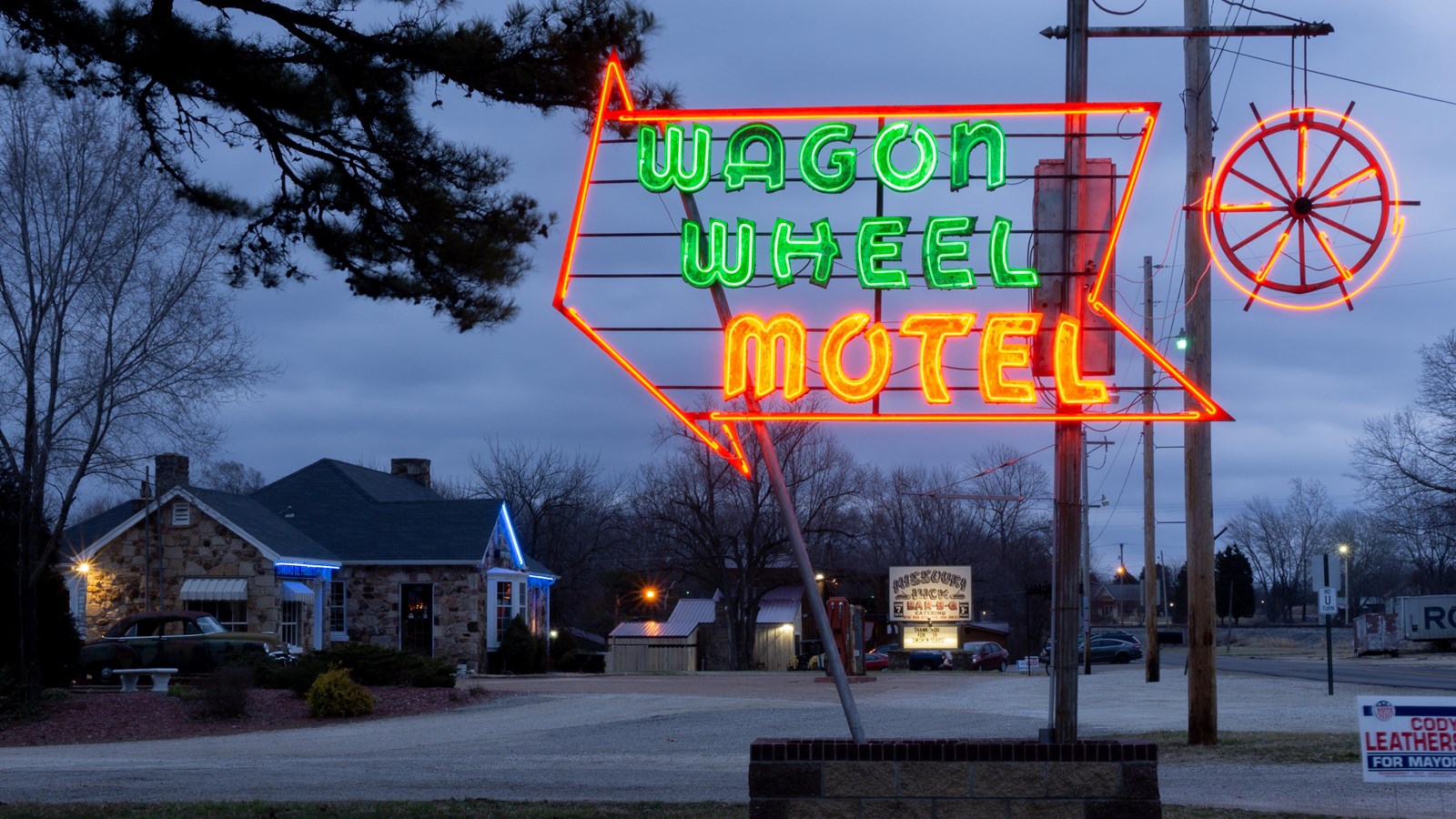 In green and orange neon lights reads