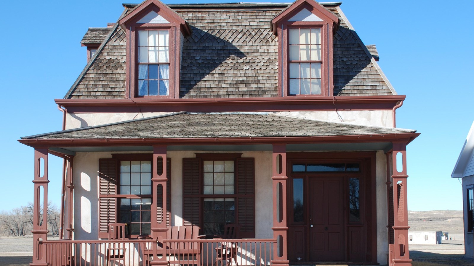 A narrow two-story, lime grout building.