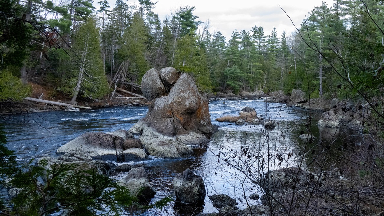 A 20ft conglomerate rock protrudes out of the East Branch of the Penobscot River.